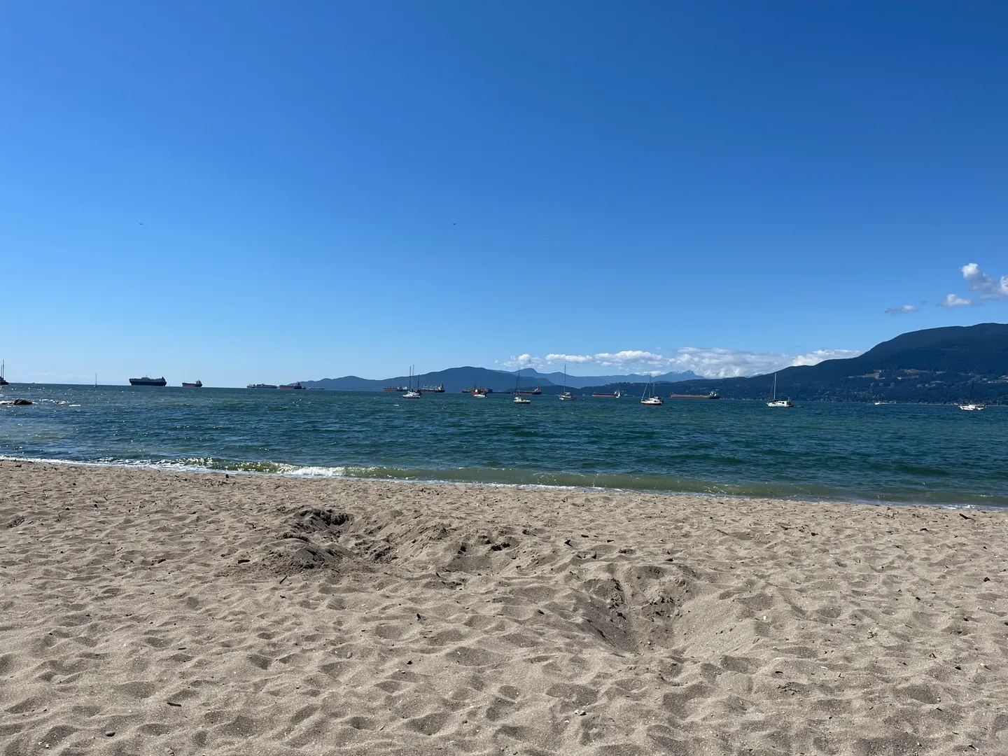 Sand, sailboats and mountains viewed from Hadden Beach