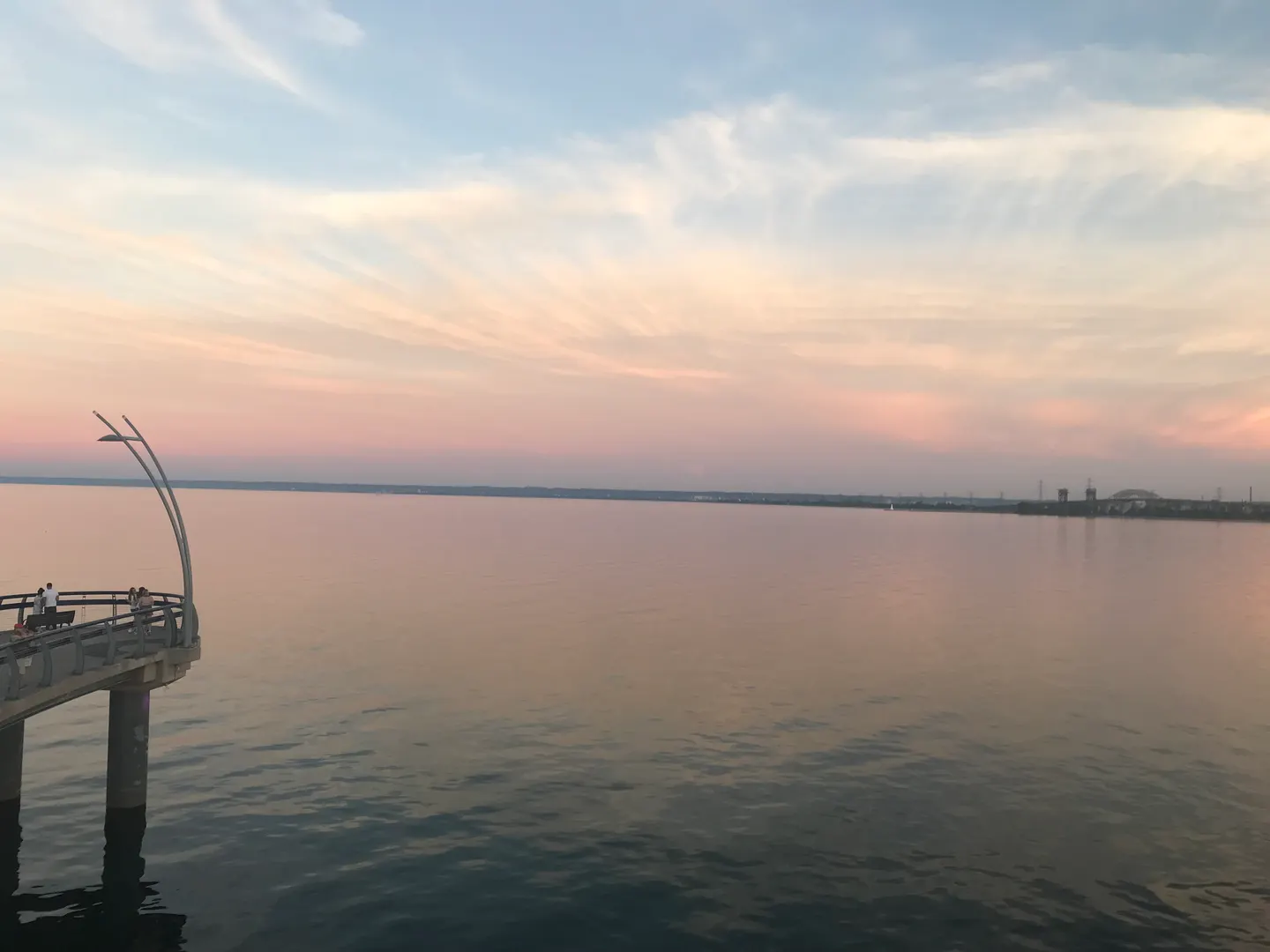 Sunset over the pier at Spencer Smith Park with pink and peach skies over calm water