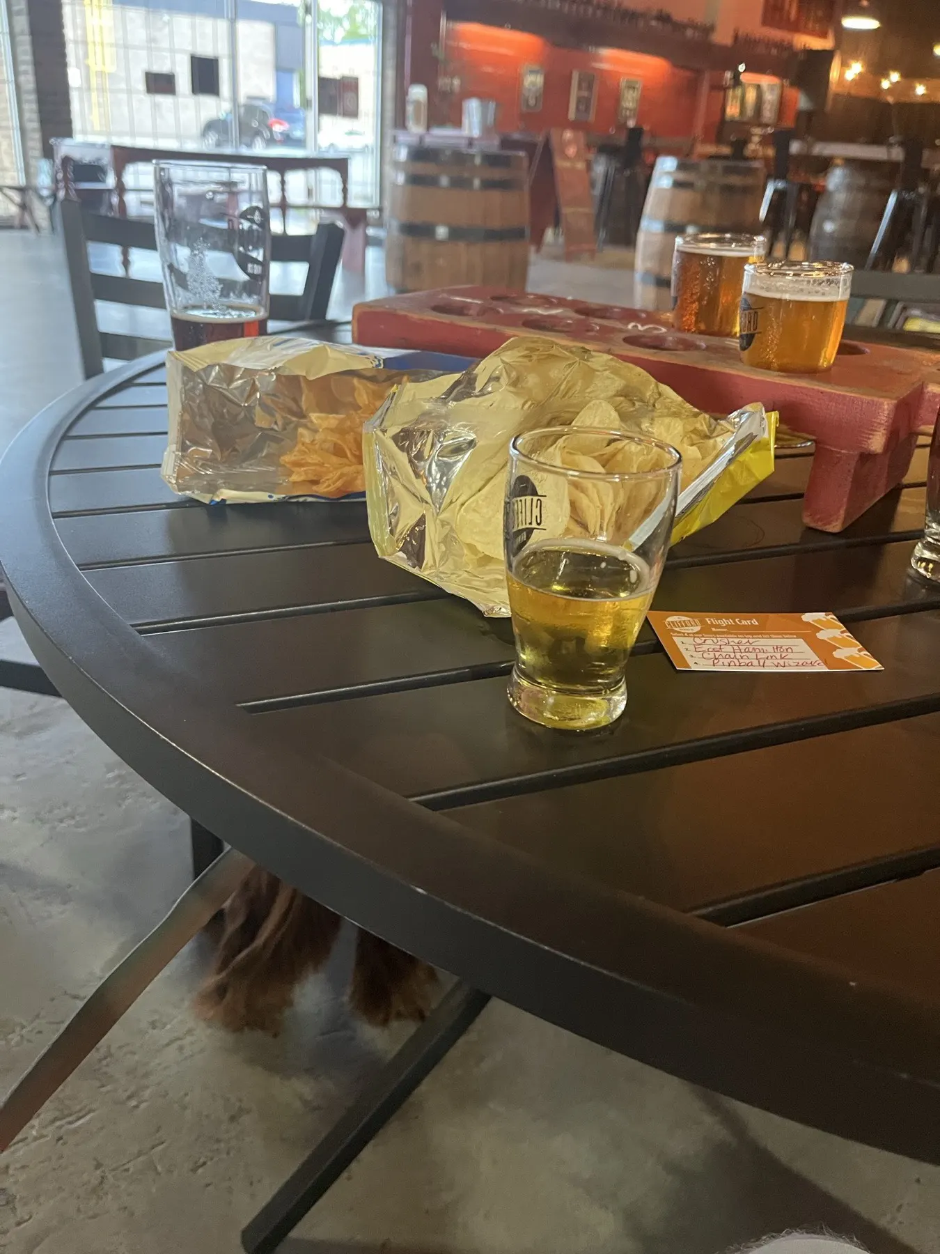 A Clifford Brewing flight and snacks on a taproom table