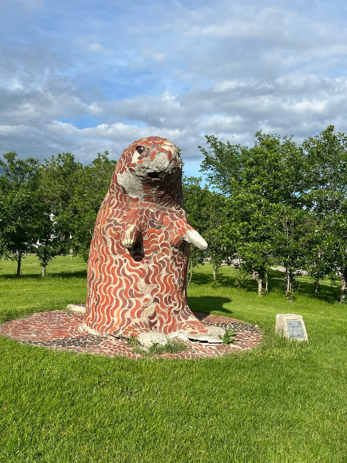 A large mosaic animal sculpture beside the route