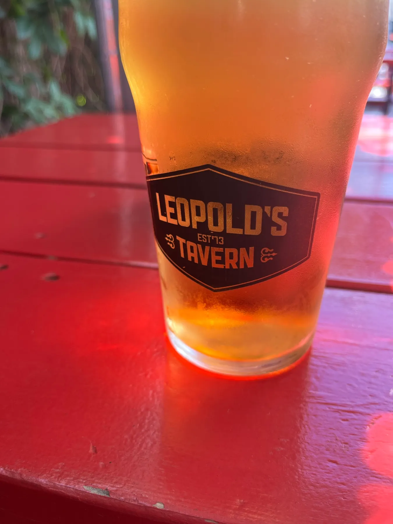 A glass of beer on a red table at Leopold's Tavern