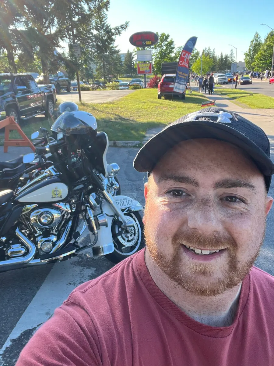 Shaun beside a police motorcycle at the classic-car event