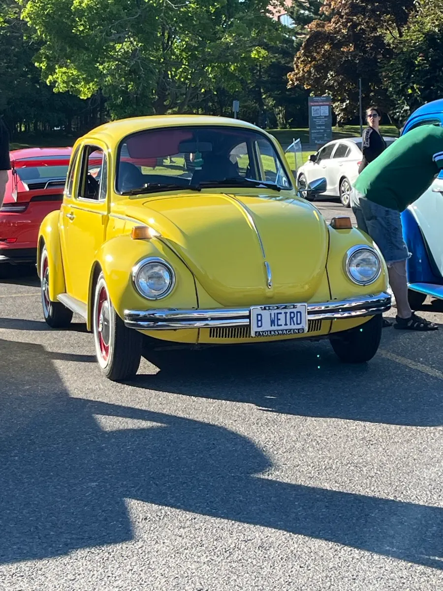 A yellow classic Volkswagen Beetle at the Sault Ste. Marie car event