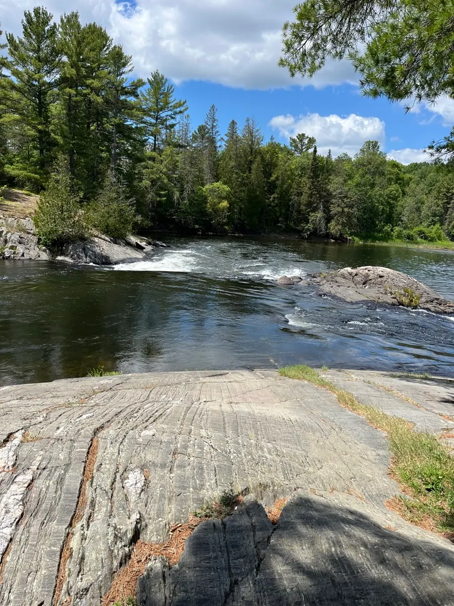 The Serpent River flowing between rocky forested banks