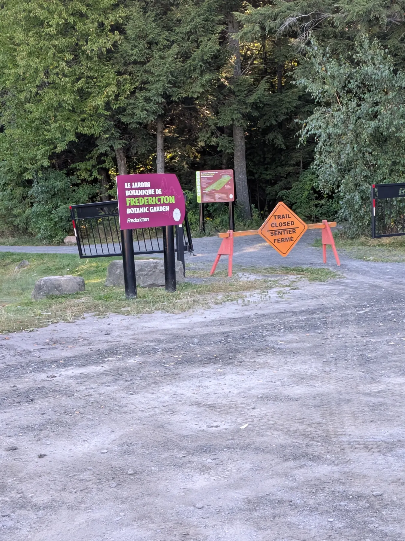 A trail closed sign blocking the entrance to the Fredericton Botanic Garden