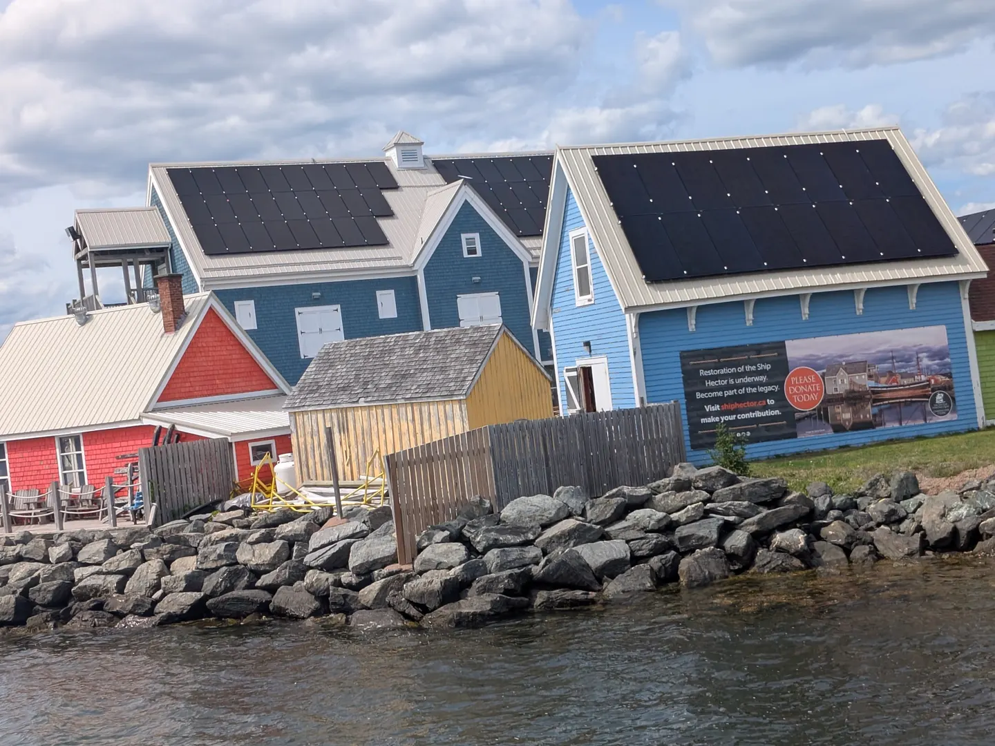 Colourful Hector Heritage Quay buildings with solar panels by the water