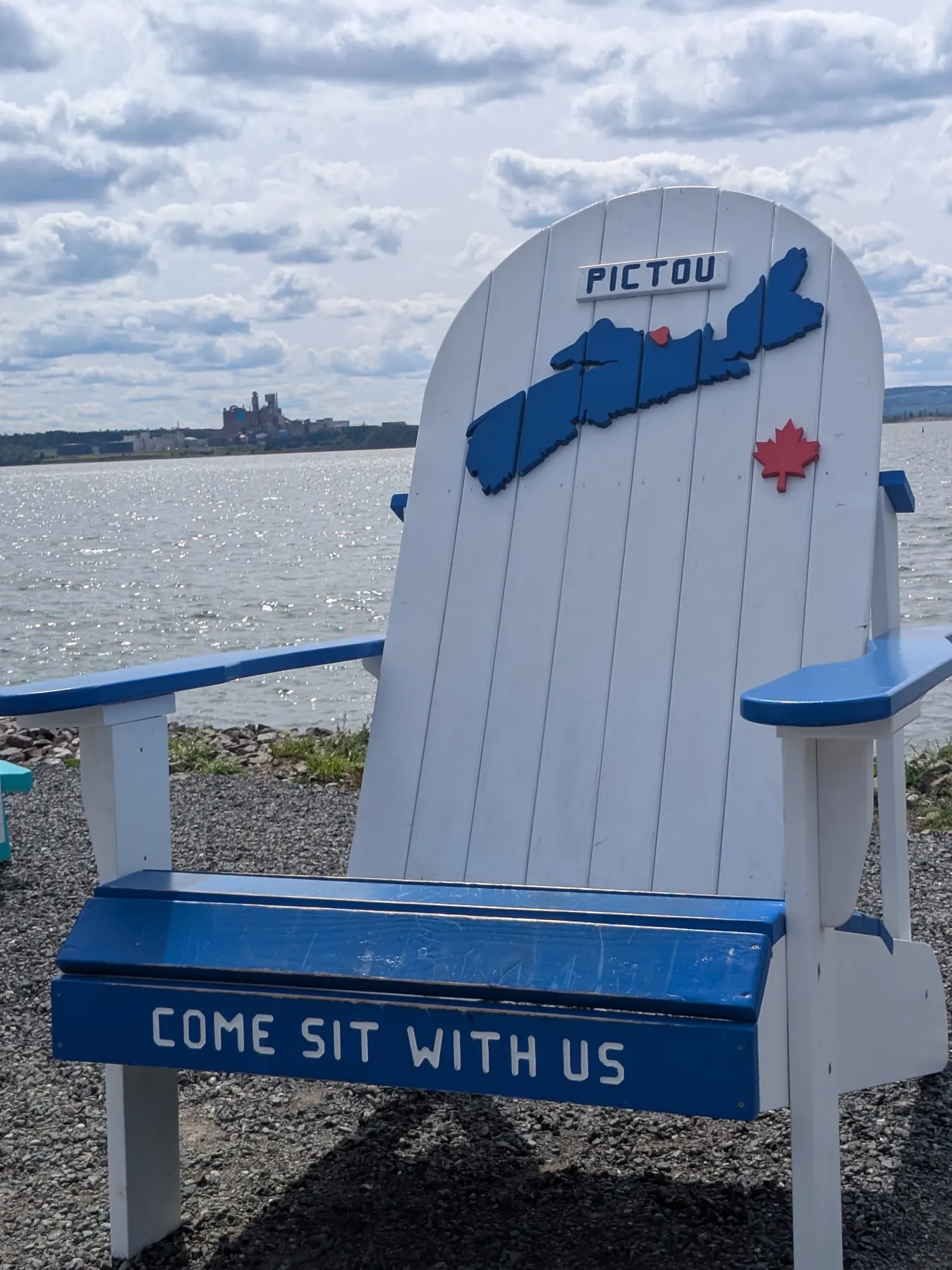 A giant Come Sit With Us chair overlooking the water in Pictou