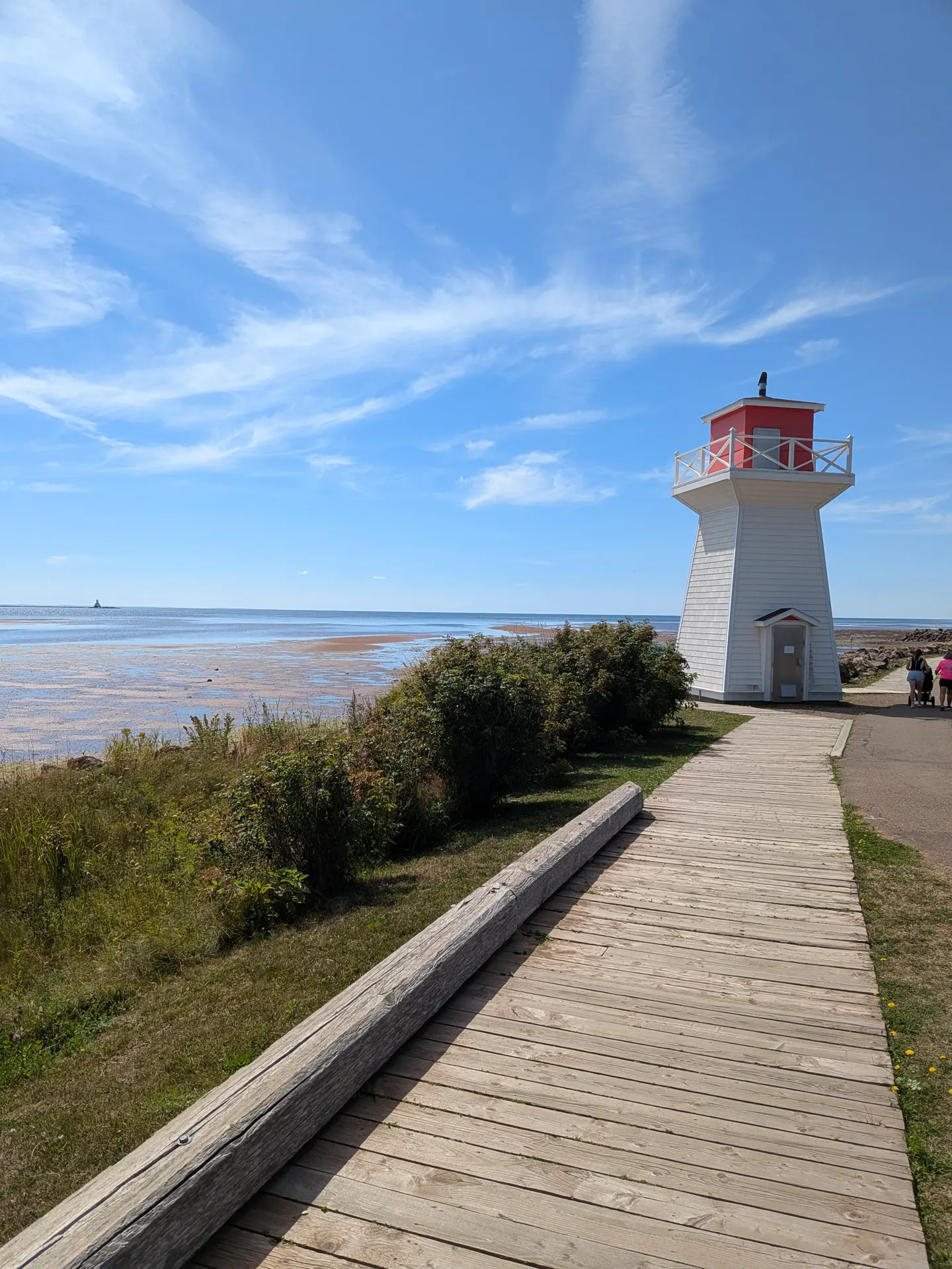 The small red-and-white lighthouse beside the Summerside Baywalk Boardwalk