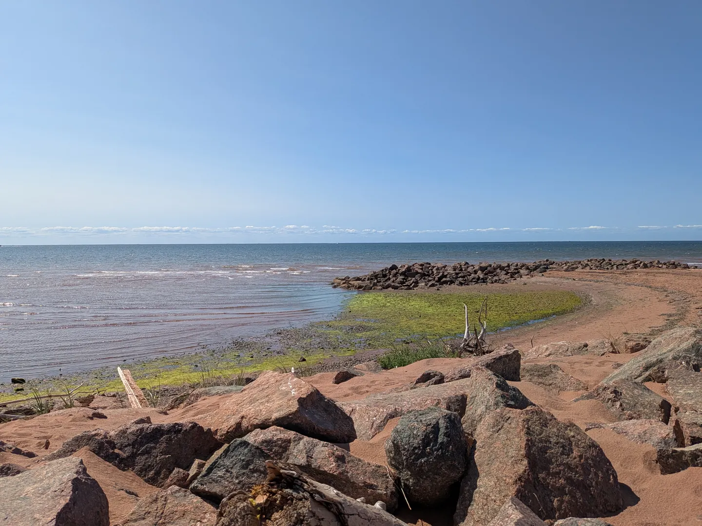 The red-sand shoreline and water at West Point